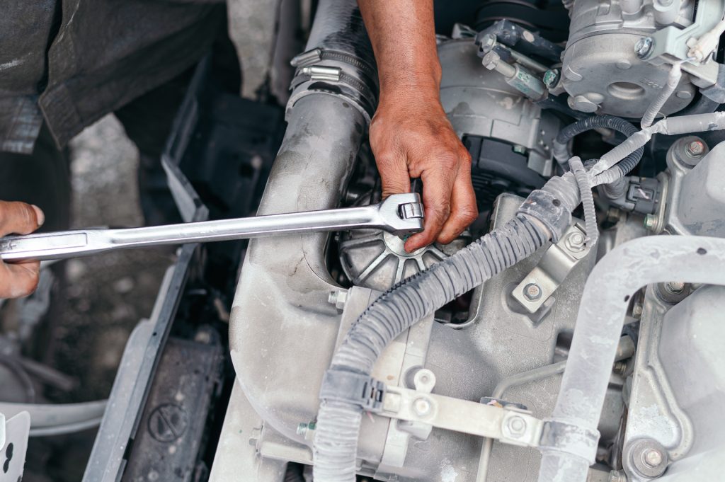 mechanic adjusting bolts